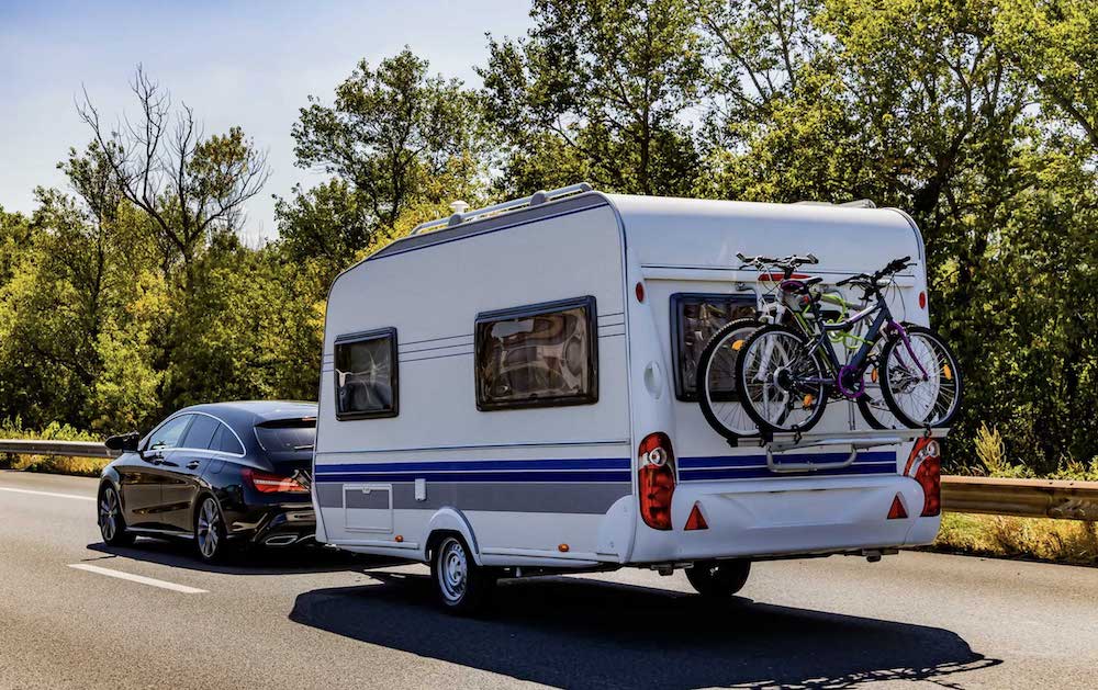 Image of a car towing a caravan showing the effect of caravan load