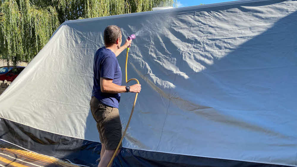 Image of a caravan owner cleaning an awning