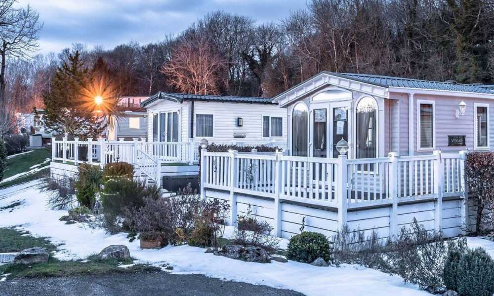 Snowy mobile homes posing the question how to keep a static caravan warm in winter